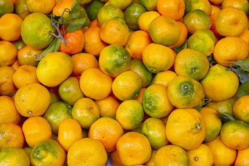 Natural tangerine fruits piled on a local market.