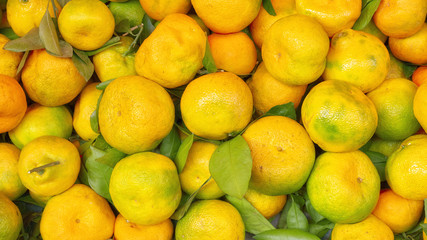 Natural tangerine fruits piled on a local market.