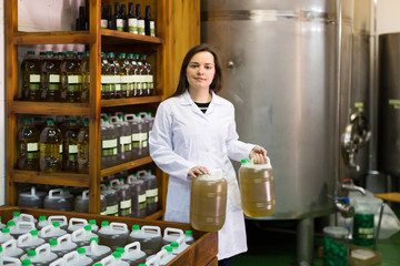 Woman near oil bottles