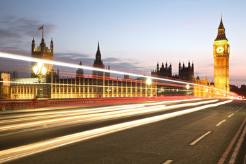 Night time view of city traffic in front of the Palace of Westminster in Westminster, London