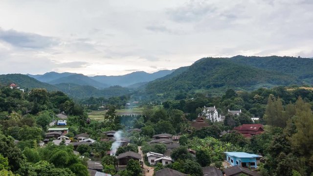 Rural village in the valley with mountain and cloud background in Thailand. 4k time lapse footage.