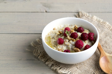 Breakfast with oatmeal and fresh raspberries.