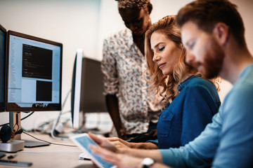 Software engineers working on project and programming in company
