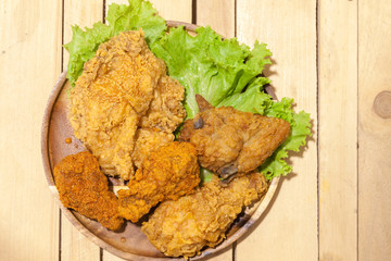 fried chickens on wooden plate