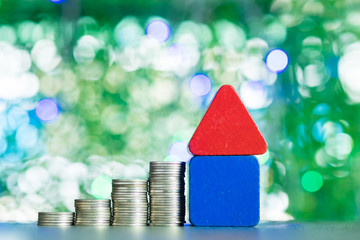 Model house wood form with step of coins stack on table, real estate investment and saving banking...