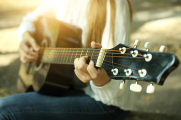 Obraz na płótnie Canvas Playing an acoustic guitar
