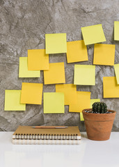 Colorful post it,memo notebook,pencil,cactus in flowerpot on white desk concrete background,work space concept