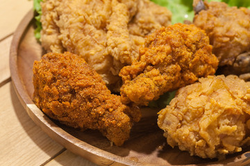 fried chickens on wooden plate