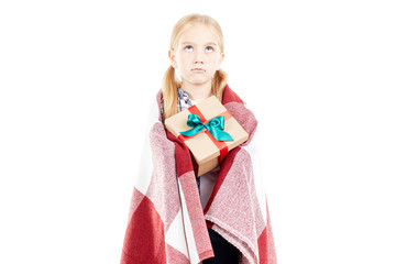 Studio portrait of little girl wrapped in blanket holding Christmas gift box