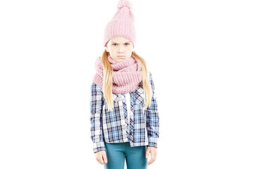 Studio portrait of little girl wearing knit hat and snood scarf