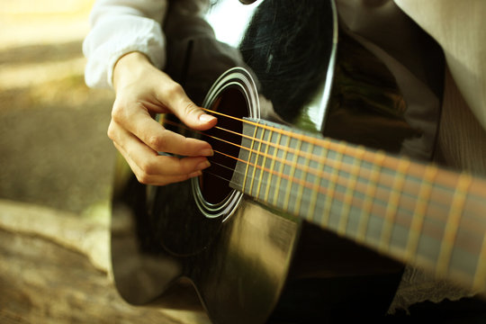 musician plays on a  guitar