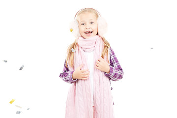 Portrait of little girl wearing scarf and winter ear muffs on white background