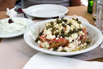 Dakos salad and Tzatziki yogurt sauce, greek meal tipycal. Taken in Naxos
