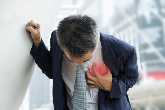 Business Man in uniform having heart attack / heartburn. acult pain possible heart attack.