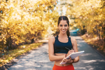 Portrait of a female fitness instructor outdoors.