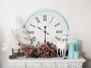 Decorative Christmas composition with fir-tree, clock, candles