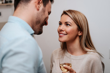 Portrait of beautiful young couple looking at each other and smiling.