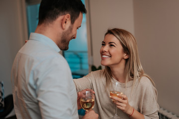 Happy couple talking and looking at each other in their home.