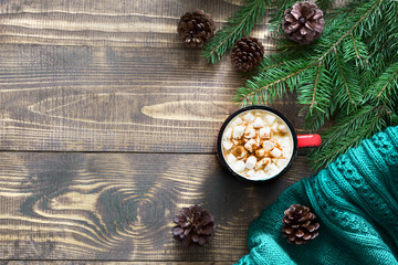 Christmas hot chocolate or cocoa with marshmallows on the wooden background and decor. Top view and copy space.
