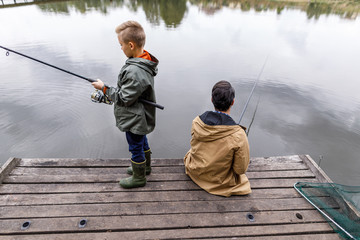 Father and son fishing with rods