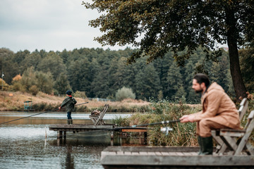 Father and son fishing on piers