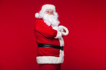 Santa Claus is dancing Isolated on red background.
