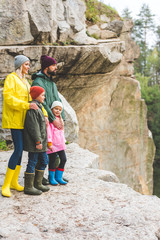family standing on rock