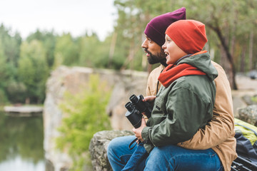 family with binoculars in forest