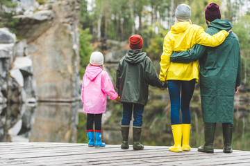 family standing on wooden bridge