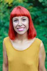 Smiling red hair girl n the park