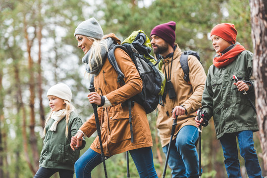 Family Walking In Autumn Forest