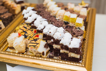 Delicious sweets on wedding candy buffet with desserts, cupcakes