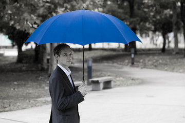 Middle aged man putting up an umbrella