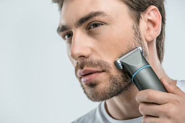 man using electric razor