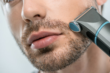 man using electric razor