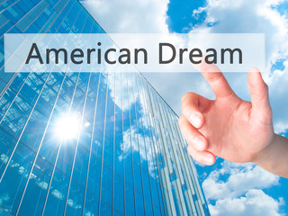 American Dream - Hand pressing a button on blurred background concept on visual screen.