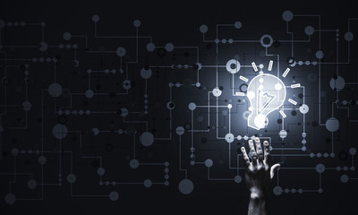 Technology idea concept with glowing bulb icon and touching it f