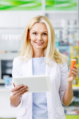 pharmacist with digital tablet and medication