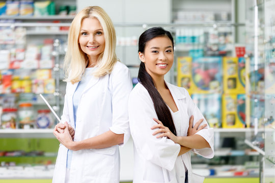 Multiethnic Pharmacists In Drugstore