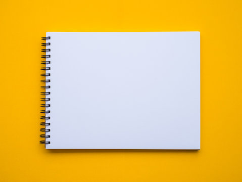 Notepad on yellow background