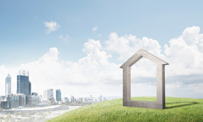 Conceptual image of concrete home sign on hill and natural landscape at background