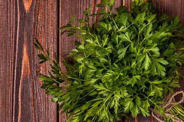 Bunch of parsley  on a wooden background.