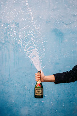 Champagne bottle with sign: Save Water drink champagne
