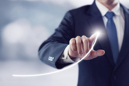 Development and growth concept. Businessman plan growth and increase of positive indicators in his business.