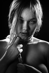 young woman with tied neck on black background choke, monochrome