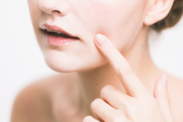 Obraz na płótnie Canvas young woman who checks her skin. acne treatment.