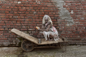 A scene of a young woman in poverty. The young woman is seen to be situated in a poor unclean...