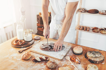 Baker with a variety of delicious freshly baked bread and pastry