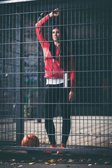 Female basketball player training outdoors on a local court