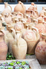 Fototapeta na wymiar Clay jugs in the garden, greens, very, harvest, vertical, pattern, selective focus